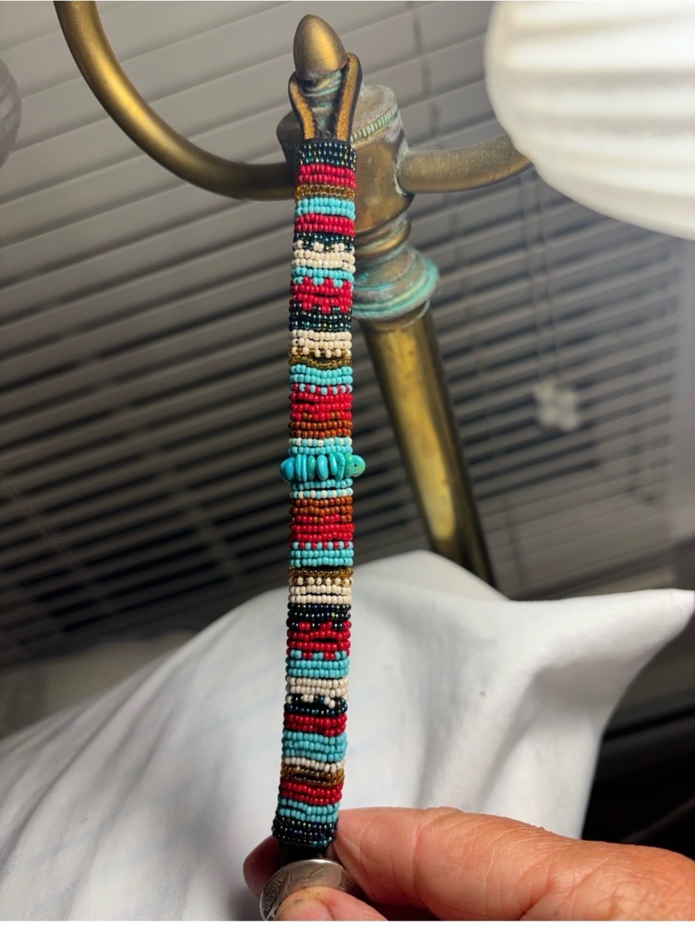 Beaded leather wrap bracelet features a distinctive, buffalo nickel coin
